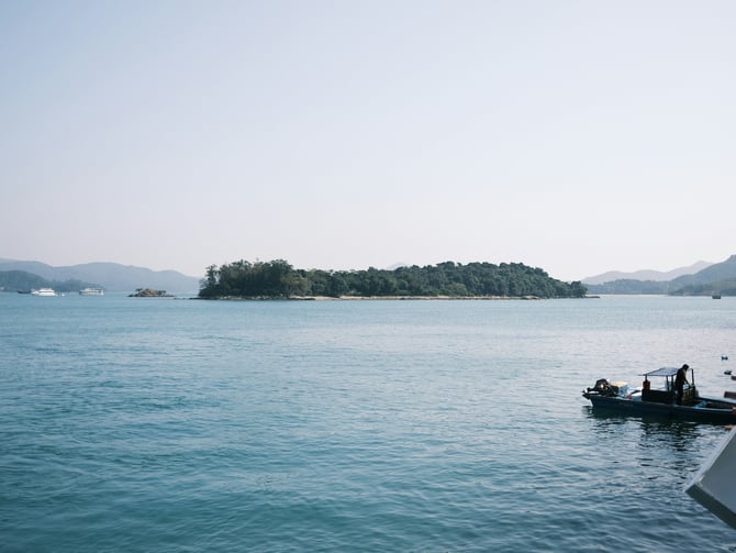 Calm lake water with a small island in the distance